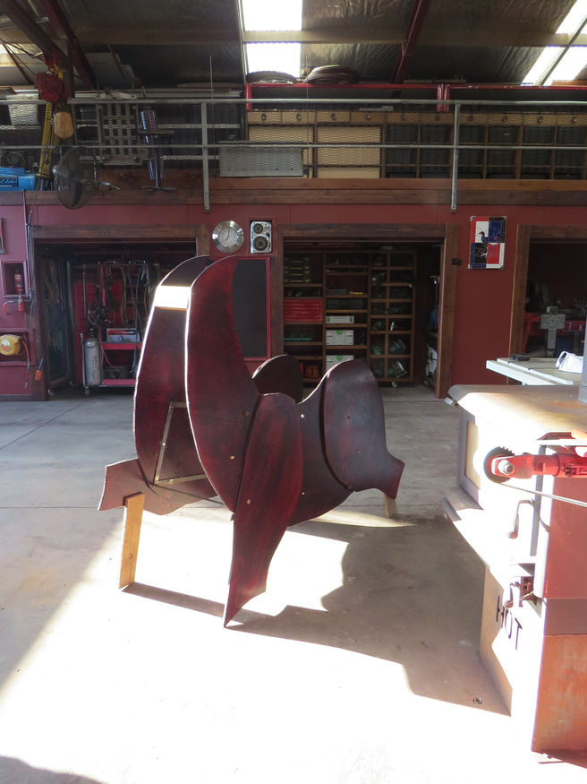 Painted panels fitted to the metal support frame of Emrys the Great Welsh Dragon, with the underlying dragon body painted red as a hidden tribute to Y Ddraig Goch.