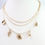 Thumbnail: Calm Seas Pearl and Shell Charm Necklace Gold