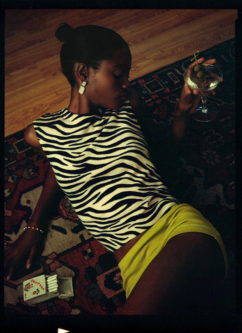 fashion photographer, Los Angeles based photographer, bts photographer, ots photographer, film photography, Los Angeles fashion photographer, black woman, 80s vibe, dirty martini, woman, at home photo shoot, black woman in 80s look, 80s style, 80s styling, guitarist, smoking, 