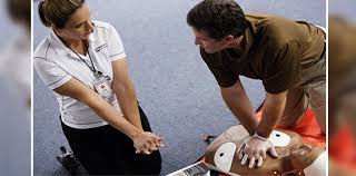 Instructor and Student simulating and performing First Aid CPR AED