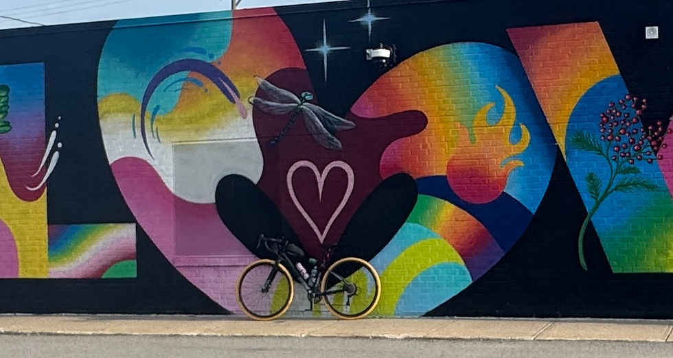 Bike parked in front of a vibrant North Kansas City mural, combining cycling and urban art.