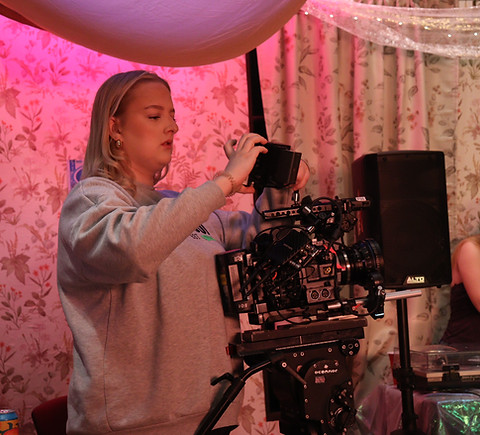 NFS student DoP adjusting monitor on camera on set
