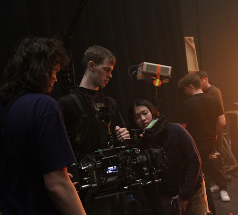NFS students holding camera in studio set