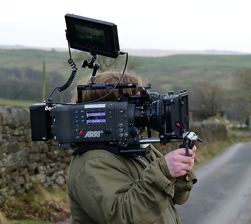 NFS student holding camera on countryside location
