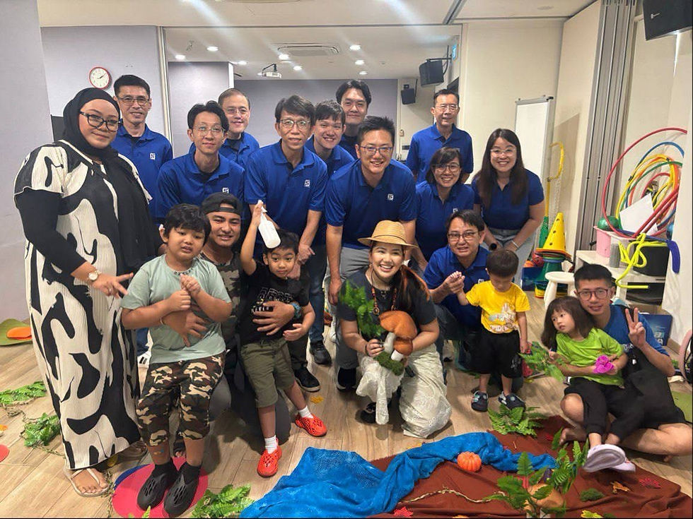 Su Paing Tun leading an inclusive community arts programme with volunteers, families, and children gathered together after the workshop.