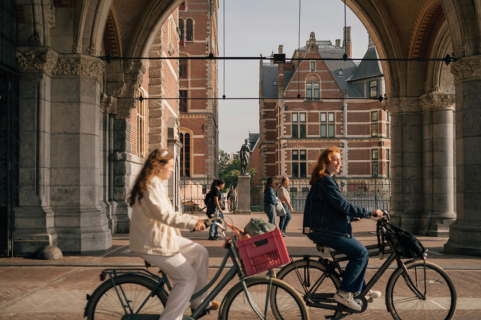 Two people on bikes in the streets of Amsterdam