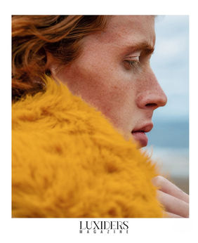 Close-up side profile photograph of redhair male model Nelson Del Toro from the Luxuders Magazine editorial, showcasing his sharp jawline and green eyes.