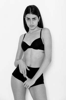 Yashira Suárez posing for professional digital polaroids in basic undergarments inside a photo studio – Female model portfolio for Salitre Models.