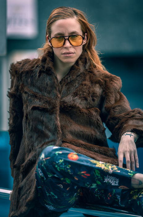 Elena Vázquez posing in a reddish fur coat and blue floral pants – High-fashion and commercial alternative female model portfolio for Salitre Models.