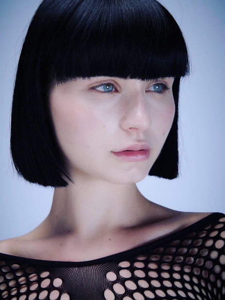 Giulia Zaffaroni international fashion model color beauty portrait close up look to the side off-camera gaze black mesh shirt fishnet top natural minimalist makeup clean beauty porcelain skin dark hair Salitre Models.