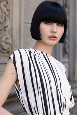 Giulia Zaffaroni international fashion model color portrait close up direct gaze vivid blue eyes black hair fair porcelain skin subtle exotic features antique Milan facade 1.76m height 89cm hips Salitre Models.