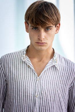 Leonardo Russo new face male model wearing a casual striped shirt and summer shorts outdoor lifestyle fashion shoot Salitre Models