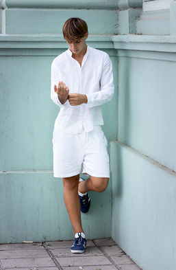 Leonardo Russo new face male model all-white resort wear look linen shirt tailored Bermuda shorts sneakers outdoor summer shoot Salitre Models