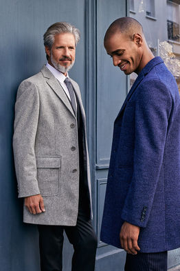 Sergi Puig international senior fashion model color photography luxury editorial elegant location navy blue suit premium grey overcoat matching tie younger male model tailored menswear silver generation Salitre Models.