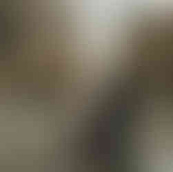 Engaged couple walking across the cross walk holding hands in Downtown Minneapolis