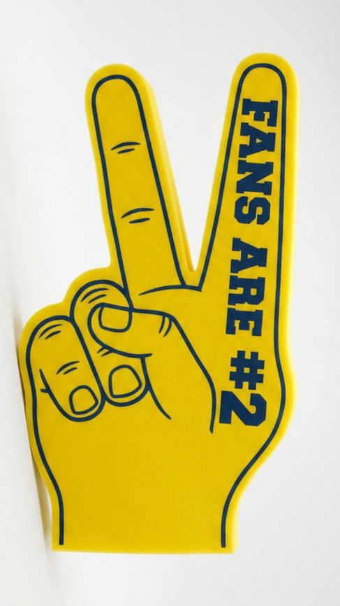 A foam sports fan hand with two fingers raised in a peace sign instead of one, bright yellow foam material, the text 'Fans Are #2' printed in bold block letters on the front of the fingers, stadium event photography style, white background, product shot