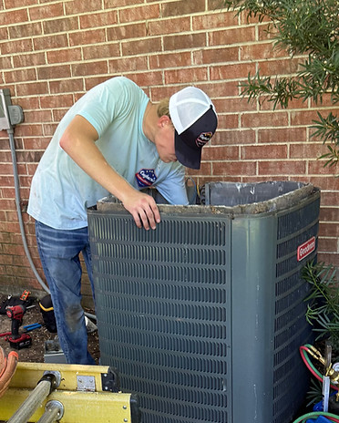 Technician completing an AC maintenance visit