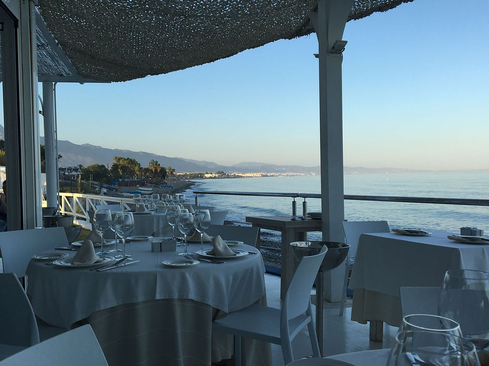 Scenic oceanfront dining at El Ancla Restaurant, offering stunning views of the coastline and mountains.