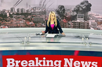 Katie Pilbeam anchoring live breaking news from a world news television studio in Istanbul