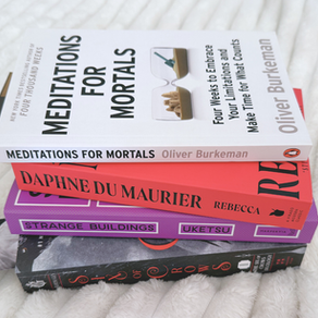 pile of books on a white blanket