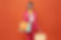 cheerful-happy-woman-enjoying-shopping-she-is-carrying-shopping-bags-orange-background.jpg