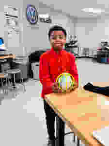 Samuel Byron poses with his globe project.
