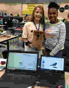 Trinity Brumlow & Morgan Conyers show the progress of their group's research, as well as their birdhouse construction.