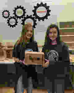 Trinity Brumlow & Lacy Pickard proudly show off their group's completed bird design.