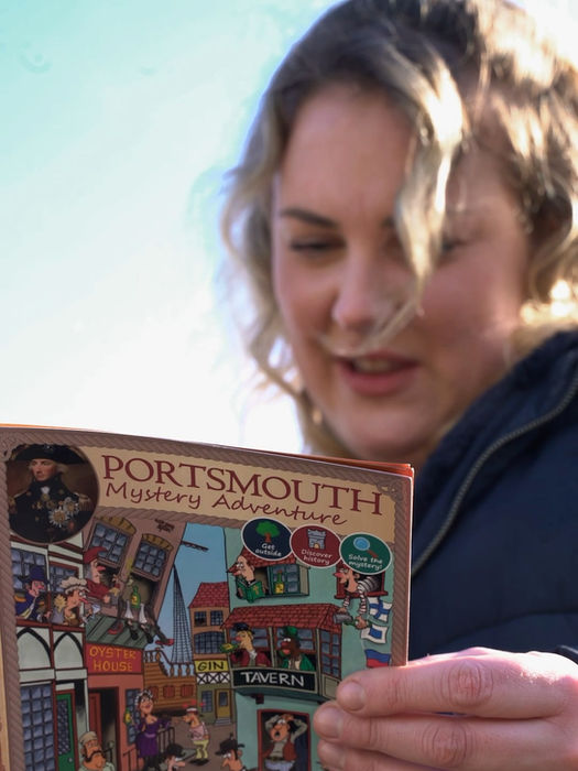 woman holding up guidebook