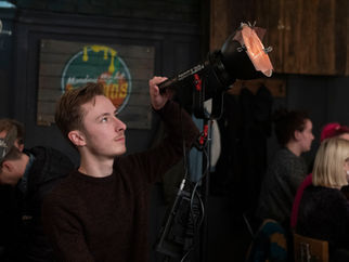 man adjusts lightstand