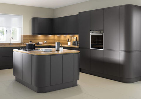 kitchen with matte dark cabinets, a wooden countertop island, under-cabinet lighting, oven, and sleek appliances