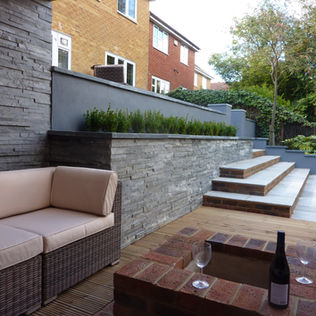 Cozy patio with wicker sofa and neutral cushions