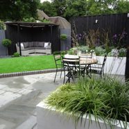 Modern garden with patio furniture and a small lawn
