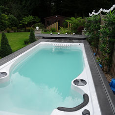 A backyard swim spa with clear water
