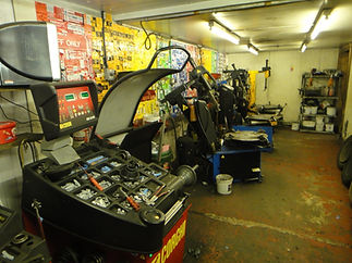 An auto repair shop with lots of tyre balancing machines
