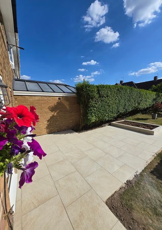 large garden patio with blooming flower basket on sunny day