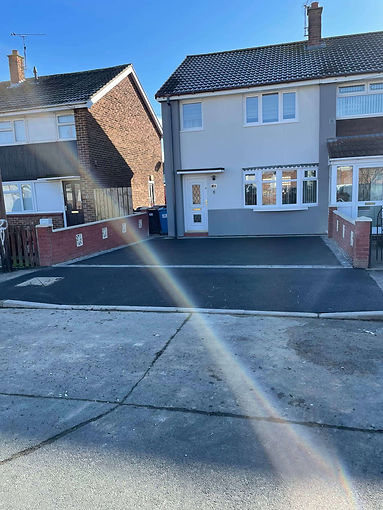 A semi-detached house with a fresh tarmac driveway