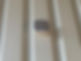 Square sensor on beige metal wall, showing alarms for all properties.
