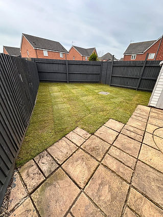 Fenced backyard with grass lawn