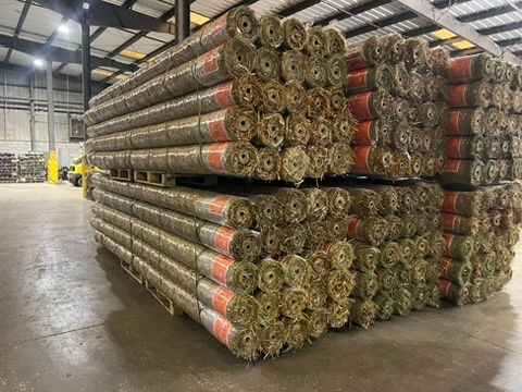 Stacks of straw mats wrapped around cardboard cores.