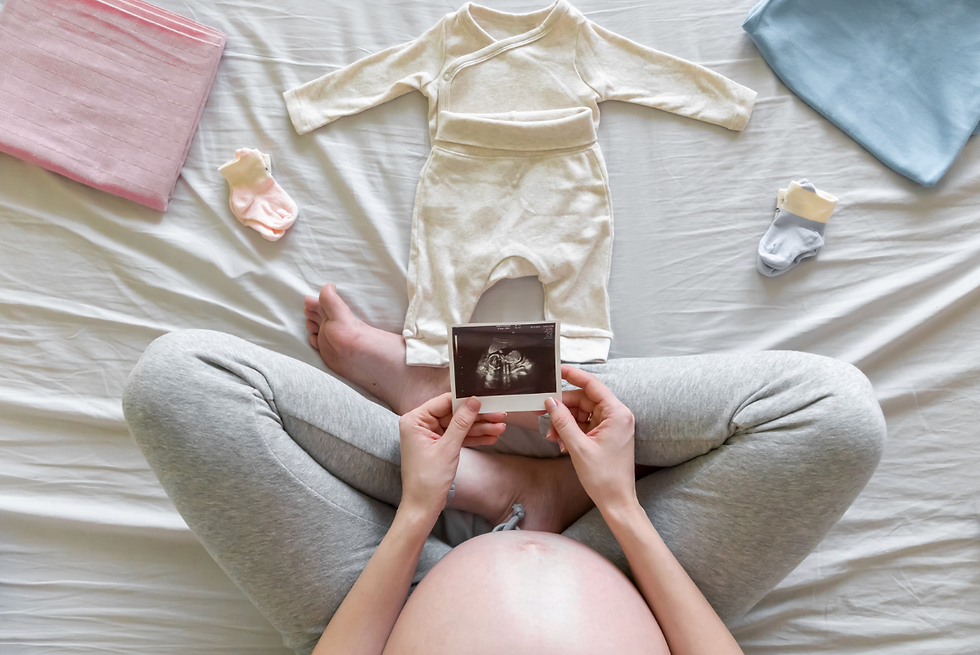 pregnant woman and baby clothes
