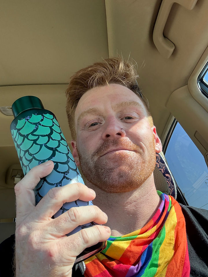 John Palmer Payne with rainbow attire and mermaid water thermos from Starbucks