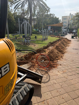 "Ami & Igal" employees are installing lighting in a park with fitness and sports facilities