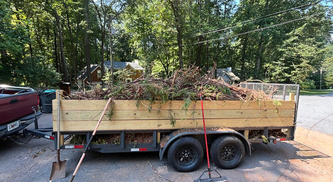 Close-up of trailer loaded with yard waste, leaves, and branches