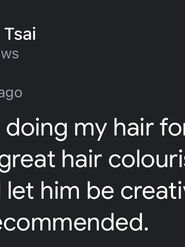 Client showing off a new personalised haircut in a Melbourne CBD salon, with a glowing 5-star Google review praising Sunny’s thoughtful and confident styling.