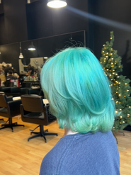 A vibrant Aruba Blue cosplay-inspired hair transformation, created by Sunny Sun Hair in Melbourne, featuring a full head bleach and vivid color styling.