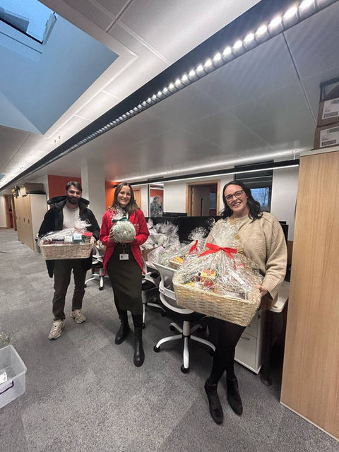 happy team delivering Christmas gifts