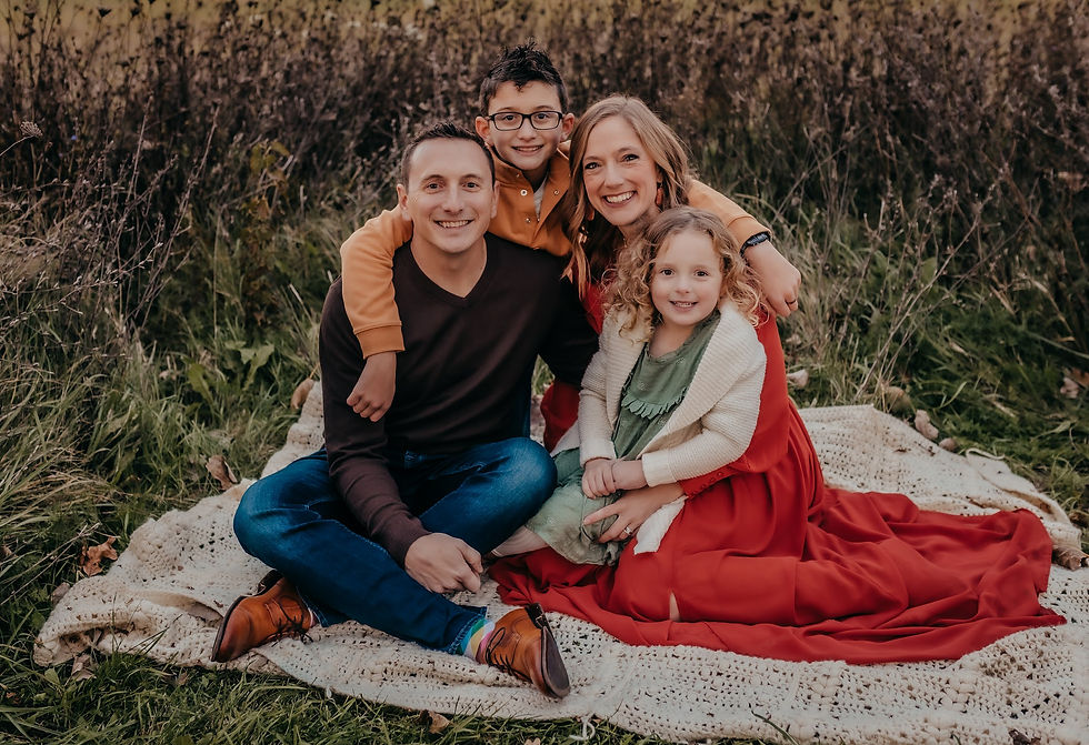 The Krick family smiling outdoors