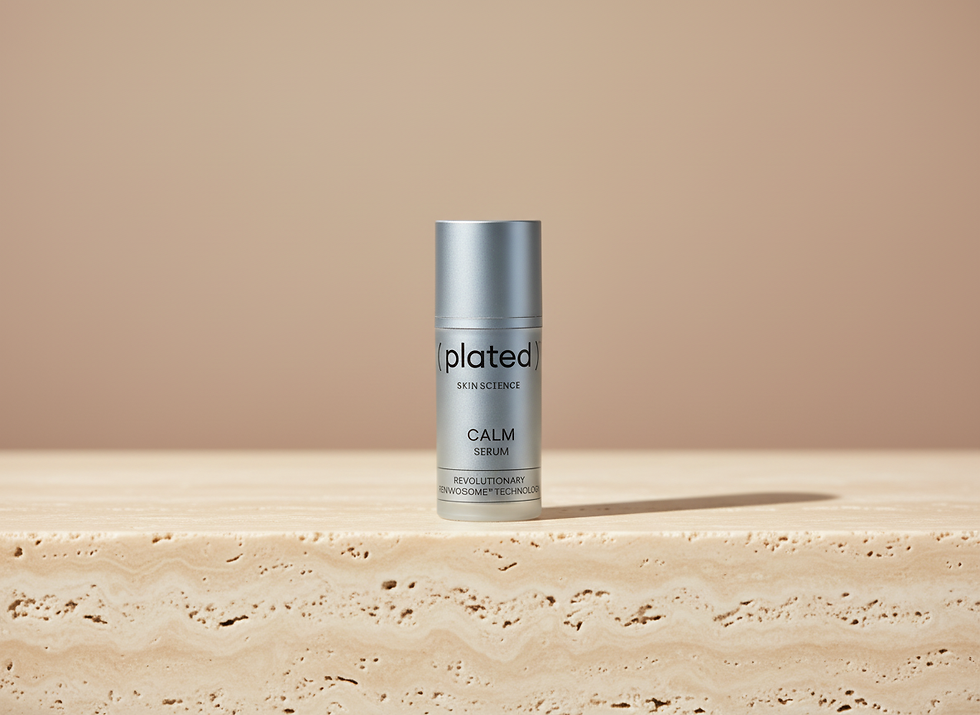Silver serum bottle with the words plated Skin Science CALM Serum ( plated ) on display.