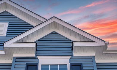 Triangle shape decorative gable with colonial white soffit and fascia on a blue horizontal